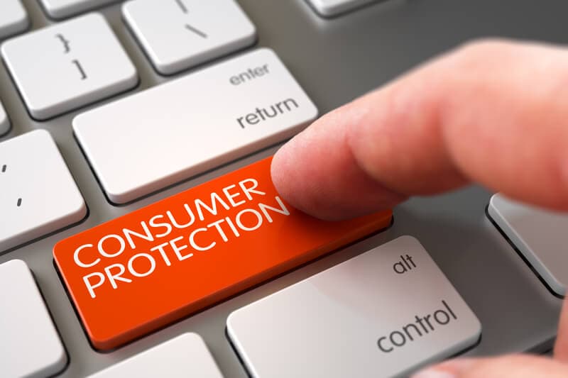 a computer keyboard with a red button that says consumer protection